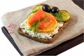 Sandwich with slices of salmon on lemon, olives, pickles, dill for breakfast and a quick snack.