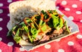 Sandwich with slow cooked smoked beef and bbq sauce at a street food market