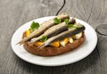 Sandwich with sprats and egg on wooden table Royalty Free Stock Photo