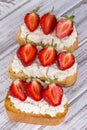Sandwich of strawberry and cottage cheese on wooden table, close up Royalty Free Stock Photo