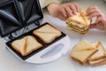 Sandwich toaster toast bread slice hand fry hold biscuit cheese morning Royalty Free Stock Photo