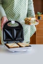 Sandwich toaster toast bread slice hand fry hold biscuit cheese morning Royalty Free Stock Photo