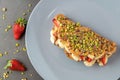 Sandwich waffles with banana, strawberry and chocolate and pistachio on top