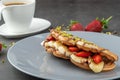 Sandwich waffles with banana, strawberry and chocolate and pistachio on top