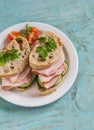 Sandwich with whole grain bread, cucumber and ham on a white plate Royalty Free Stock Photo