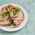 Sandwich with whole grain bread, cucumber and ham on a white plate Royalty Free Stock Photo