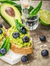 Sandwiches with avocado, blueberries and spinach