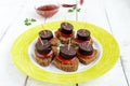 Sandwiches with black rye bread in the shape of a heart, blood sausage Morcillo and pieces of sweet pepper on skewer
