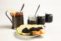 Sandwiches with black sturgeon caviar, lemon slice and tartlet with black caviar on a plate. Royalty Free Stock Photo