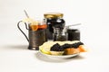 Sandwiches with black sturgeon caviar, lemon slice and tartlet with black caviar on a plate. Royalty Free Stock Photo