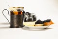 Sandwiches with black sturgeon caviar, lemon slice and tartlet with black caviar on a plate. Royalty Free Stock Photo