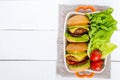 Sandwiches burgers with yellow and black tomatoes, juicy cutlet, avocado