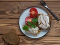 Sandwiches with chicken ham and tomatoes for breakfast. A plate stands on a brown wooden tray Royalty Free Stock Photo