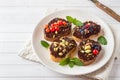 Sandwiches with chocolate paste, pistachio nuts and fresh berries on a plate. Royalty Free Stock Photo