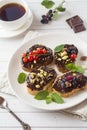 Sandwiches with chocolate paste, pistachio nuts and fresh berries on a plate. Royalty Free Stock Photo