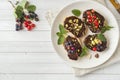 Sandwiches with chocolate paste, pistachio nuts and fresh berries on a plate. Copy space Royalty Free Stock Photo