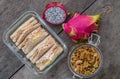 sandwiches in glass box with granola and pitaya fruit on wooden table for breakfast, top view Royalty Free Stock Photo