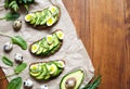 Sandwiches with guacamole, avocado, spinach, arugula and quail eggs on parchment. Low carbohydrate diet of organic Royalty Free Stock Photo