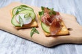 Sandwiches with ham and vegetables on a wooden board Royalty Free Stock Photo