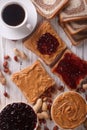 Sandwiches with jam, peanut butter and coffee top view Royalty Free Stock Photo