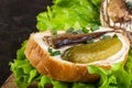 Sandwiches made of sprots and cucumbers on lettuce leaves and wood board Royalty Free Stock Photo