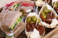 Sandwiches with meat and vegetables and baskets with dried tomatoes