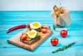 Sandwiches with olive, quail eggs, cherry tomatoes and potatoes on a wooden blueboard. Royalty Free Stock Photo