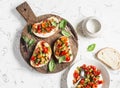 Sandwiches with quick ratatouille on rustic cutting board on a light background. Delicious healthy vegetarian food