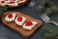 Sandwiches with red caviar are located on a wooden board Royalty Free Stock Photo