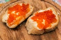 Sandwiches with red caviar. Caviar of red salmon. Luxurious culinary delicacy. Closeup of salmon caviar with butter. Seafood