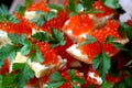 Red caviar is laid on a piece of bread garnished with parsley leaves Royalty Free Stock Photo