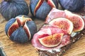 Sandwiches with ricotta cheese, fresh figs and ham, bacon ham prosciutto on rustic wooden cutting board, top view. Delicious tast Royalty Free Stock Photo
