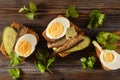 3 sandwiches with rye bread, sprats, fresh cucumber and boiled eggs