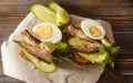 Sandwiches with rye bread, sprats, fresh cucumber and eggs