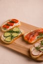 Sandwiches with salmon, cucumber, tomatoes, avocados and greens, vegetable sliced