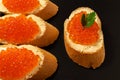 Sandwiches with salmon red caviar on a dark stone background Royalty Free Stock Photo