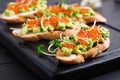 Sandwiches with salmon red caviar and salsa with avocado. Royalty Free Stock Photo