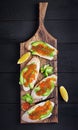 Sandwiches with salmon red caviar with sliced avocado. Royalty Free Stock Photo