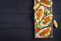 Sandwiches with salmon red caviar with sliced avocado. Royalty Free Stock Photo