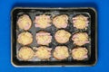 Sandwiches with sausage and cheese in a baking tray in the oven. The process of preparing a quick meal