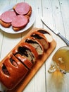 sandwiches with sausage, green tea, butter and roll with poppy seeds on a white table Royalty Free Stock Photo