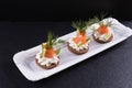 Sandwiches of smoked salmon, dill and sauce on a board