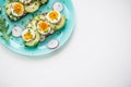 Sandwiches with soft boiled egg, avocado, radish, arugula Royalty Free Stock Photo