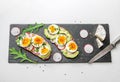 Sandwiches with soft boiled egg, avocado, radish, arugula, green onion and flax seeds and camembert cheese Royalty Free Stock Photo