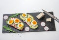 Sandwiches with soft boiled egg, avocado, radish, arugula, green onion Royalty Free Stock Photo