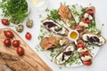 Sandwiches with soft cheese, red fish, eggs and tomatoes Royalty Free Stock Photo