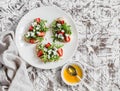 Sandwiches with strawberries, arugula and blue cheese on a white ceramic plate, on a light background. Royalty Free Stock Photo