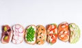 Set of colorful sandwiches prepared with different ingredients such as fish, vegetables and meat Royalty Free Stock Photo