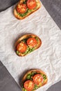 Sandwiches on toasted white bread with spinach cheese decorated with tomato slices. Shoot from above