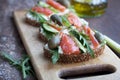 Sandwiches with trout, capers and arugula on wooden desk